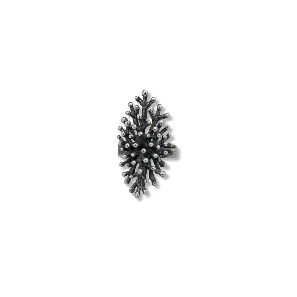 Textured silver-plated statement ring with pinecone-inspired organic structure, worn on finger